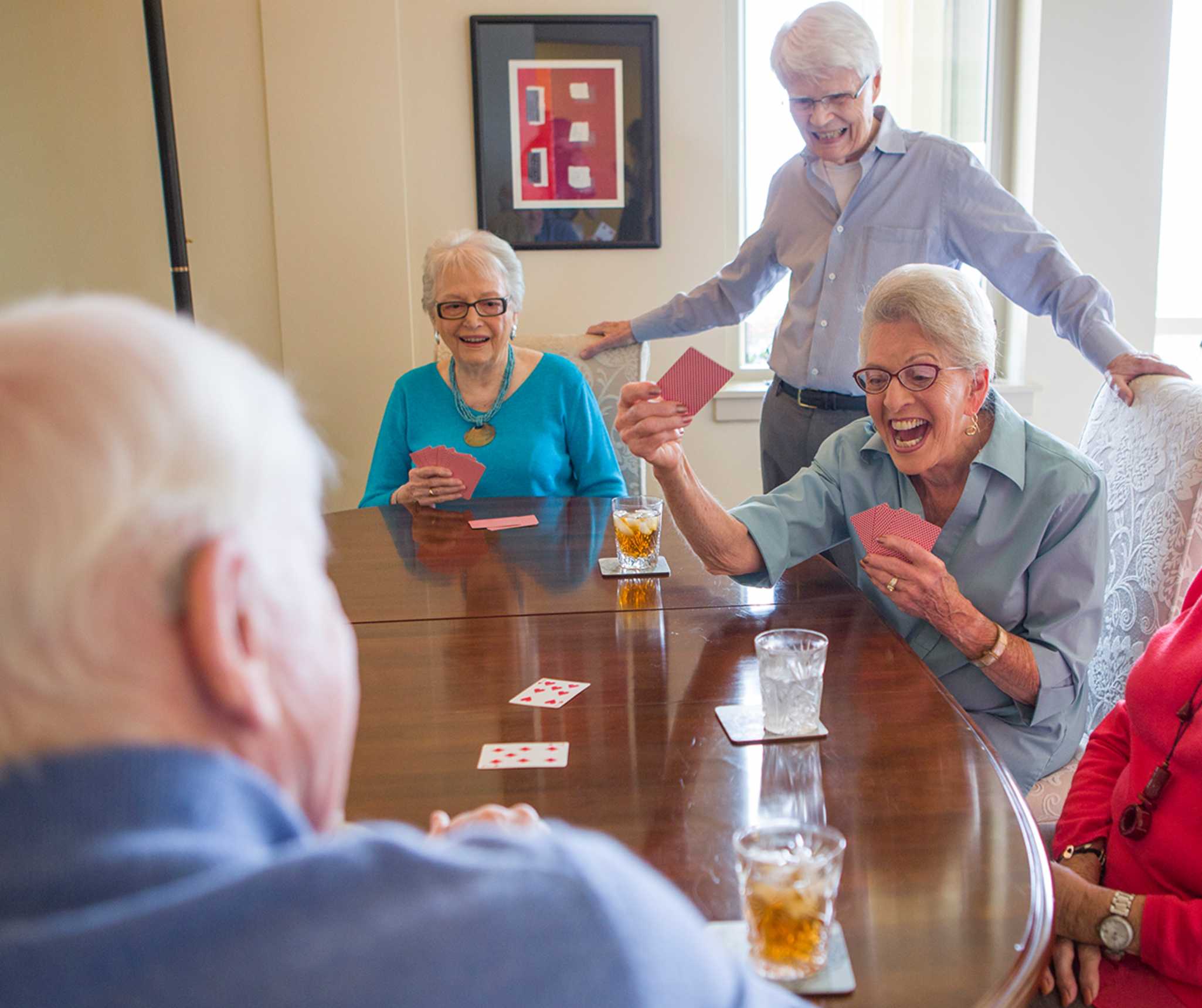 senior community residents play an exciting card game together