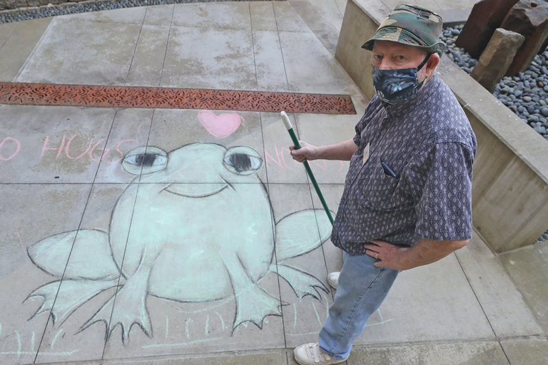 Timber Ridge resident in front of chalk drawing