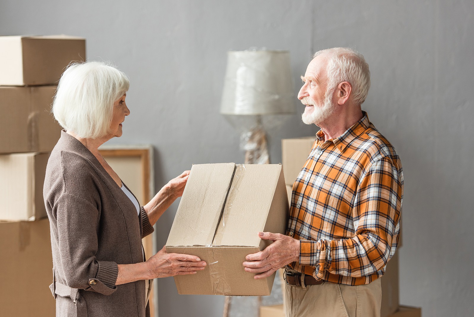Senior couple downsizing and packing up belongings together
