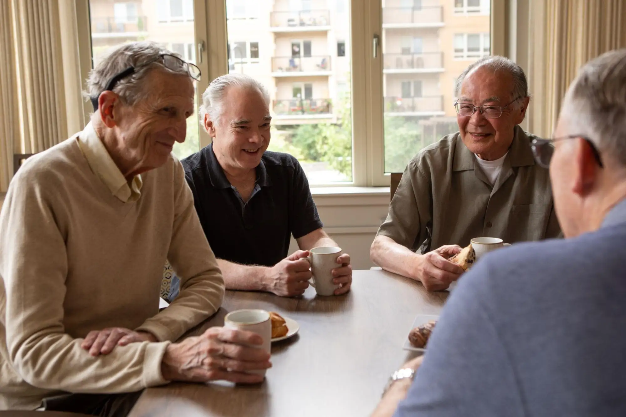 a group of Timber Ridge at Talus residents sitting around the table drinking coffee and chatting