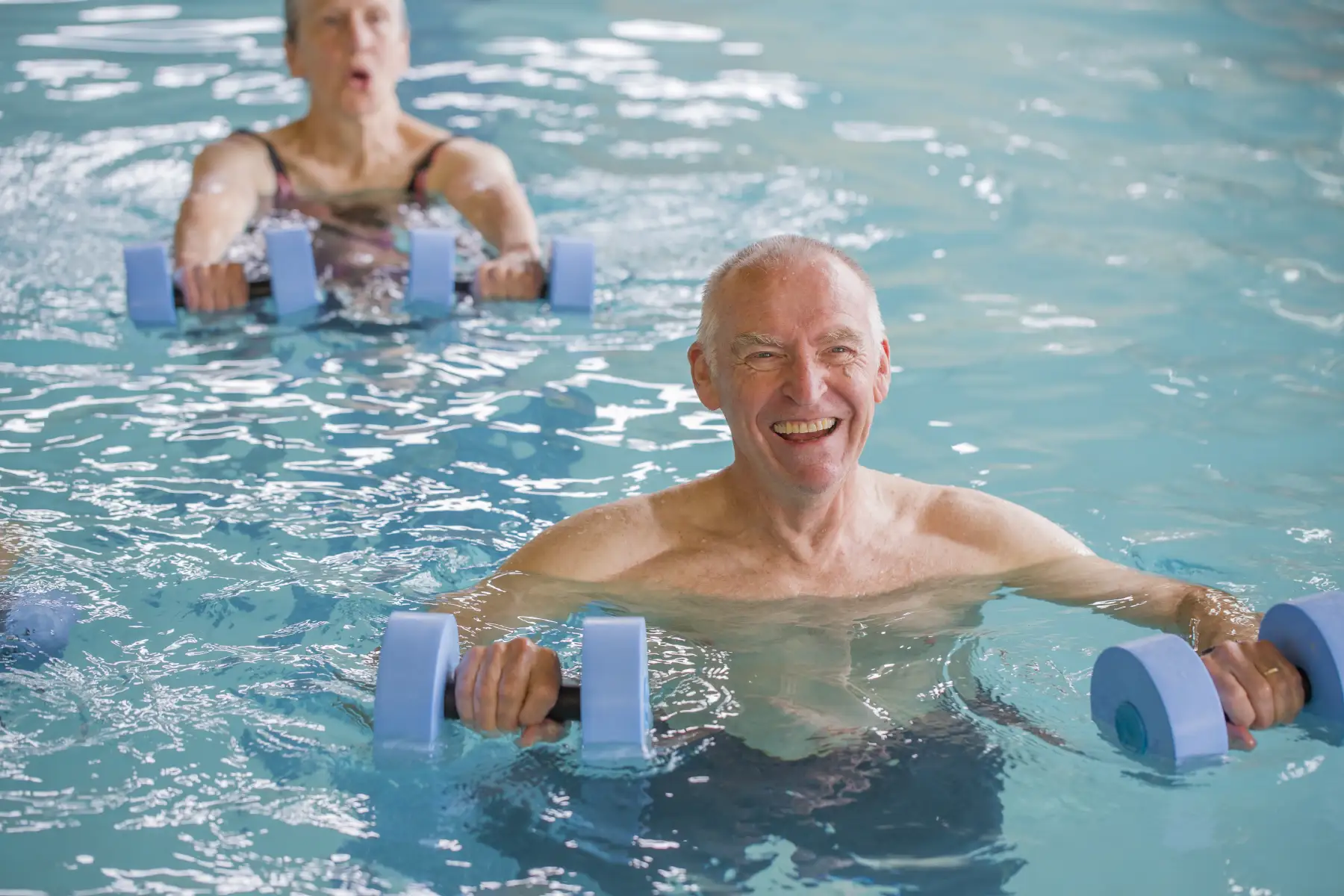 a group of seniors participating in a water aerobics class