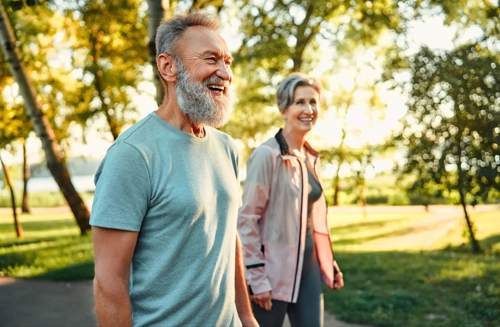 A senior couple enjoying active aging at Timber Ridge at Talus in Issaquah, WA, by walking on local nature trails.