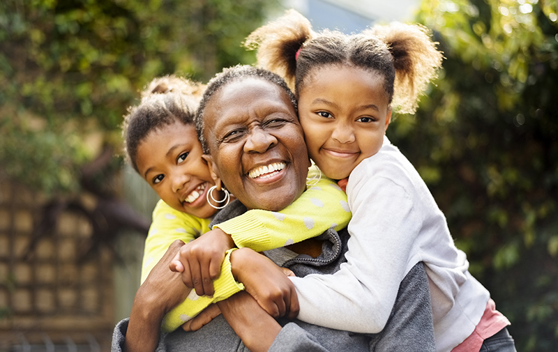 woman huggin her grandchildren