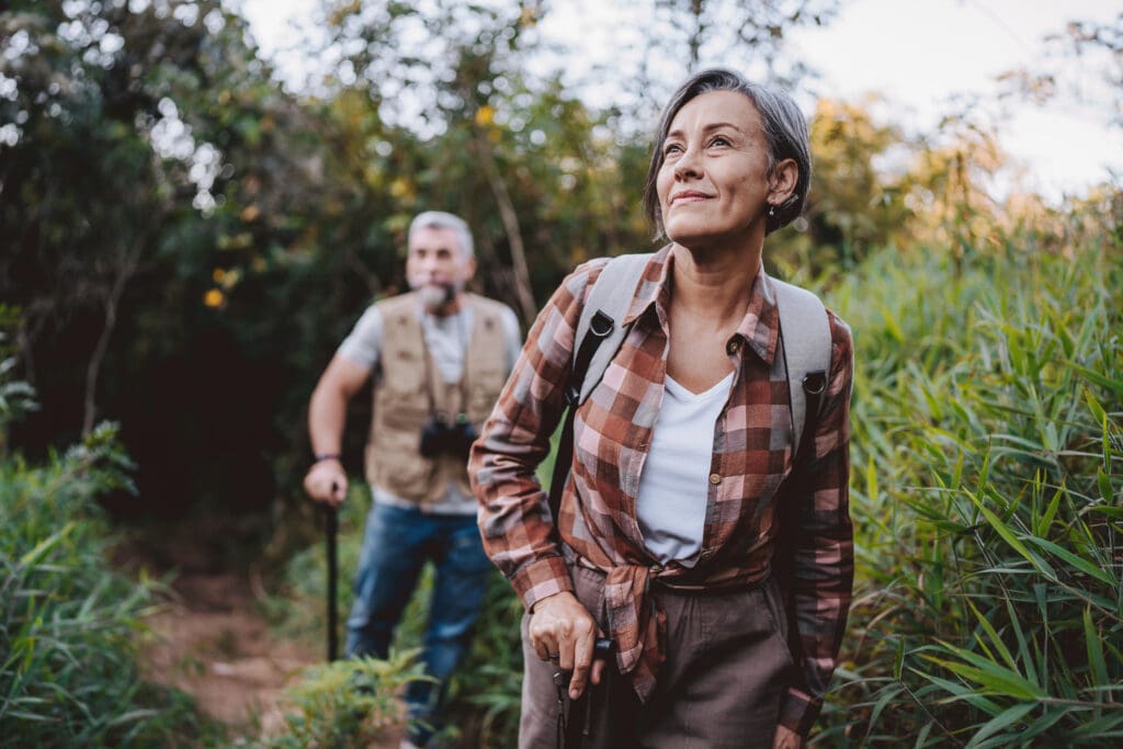 Two seniors hiking a trail