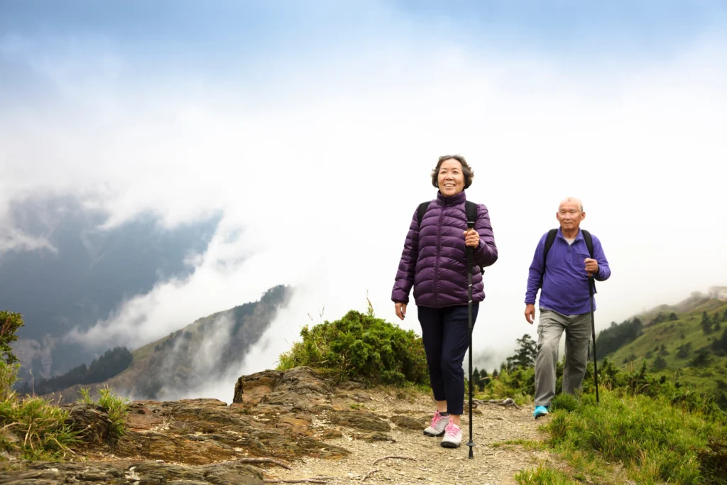 An elderly couple hiking on senior-friendly trails in Issaquah, Washington near Timber Ridge at Talus