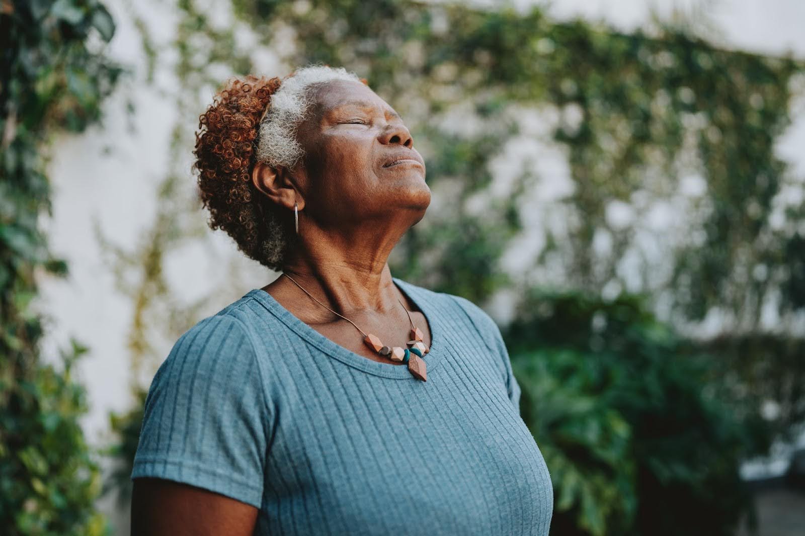 Senior woman enjoying nature and meditation