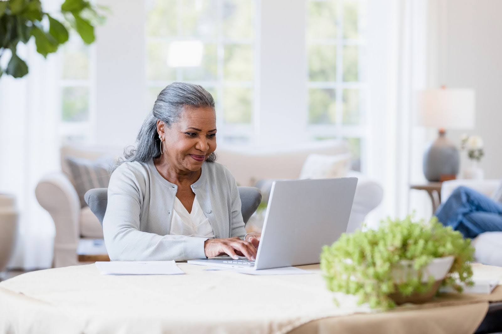Senior woman typing on her computer